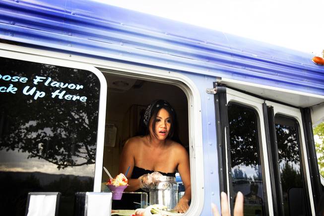 Roxanne Delacaza serves up shave ice at the Snow Ono truck at the Las Vegas Farmers' Market at Gardens Park in Summerlin Tuesday, August 2, 2011.