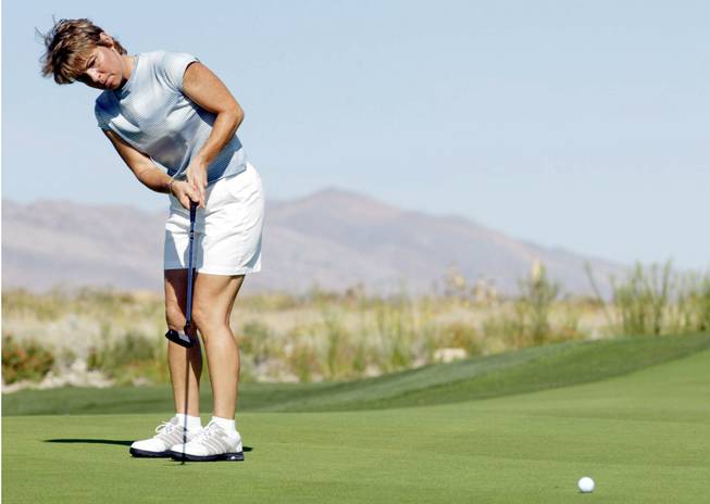 CPA and golfer Laurie Johnson works on her putting before taking part in the Nevada Womens Golf Association Amateur Championship at Las Vegas Paiute Golf Resort, September 3, 2003.
