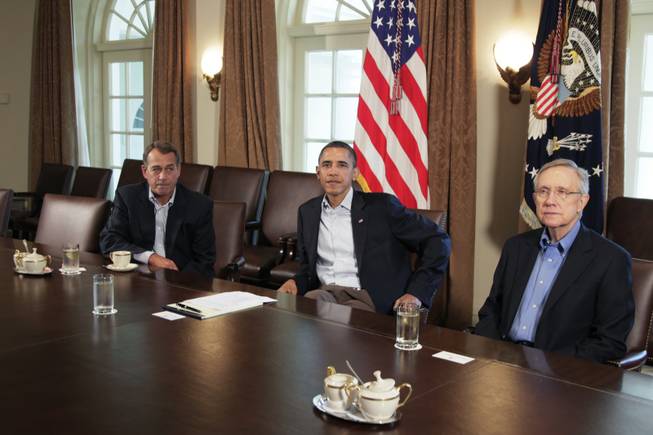 President Barack Obama meets with Senate Majority Leader Harry Reid, right, and House Speaker John Boehner, in the Cabinet Room of the White House July 23.