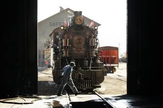 Train master Adam Nini prepares the 1909 steam powered locomotive for the train ride outside the machine shop at the Nevada Northern Railway Museum in Ely Monday, August 8, 2011.