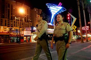 Metro Police Officers Bryce Jones and Rachel Calderon patrol Fremont Street in downtown Las Vegas on Monday, Aug. 8, 2011, as part of an initiative called Crime Free Corridor, a plan to reduce crime downtown.
