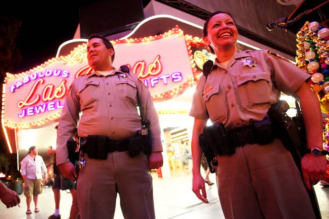 Metro Police Officers Rachel Calderon and Bryce Jones patrol Fremont Street in downtown Las Vegas on foot Monday, Aug. 8, 2011, as part of an initiative called Crime Free Corridor, a plan to reduce in crime in the downtown area.