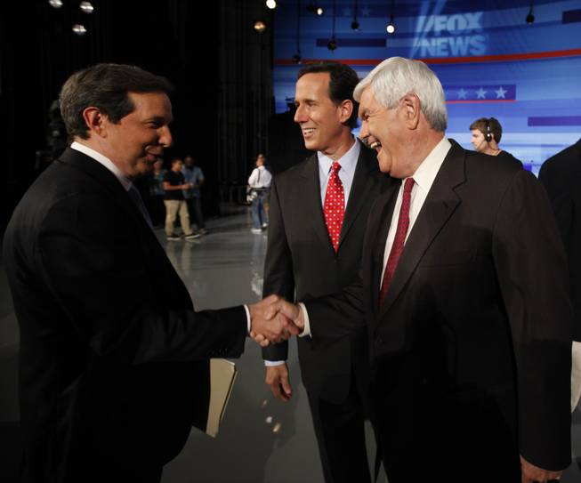 Republican presidential candidates former House Speaker Newt Gingrich and former Pennsylvania Sen. Rick Santorum greet Fox News' Chris Wallace at the end of the Iowa GOP/Fox News Debate at the CY Stephens Auditorium in Ames, Iowa, Thursday, Aug. 11, 2011.