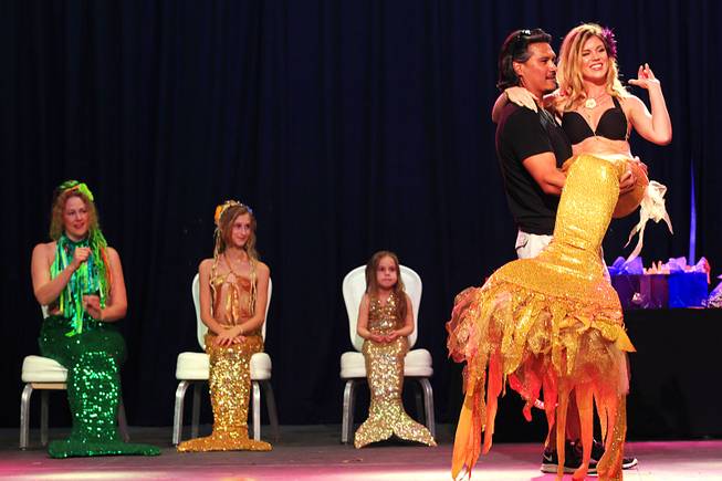 Juliana Tucker is carried onstage by Joe Davila during the first International Mermaid Pageant held as part of MerCon 2011 at Silverton Casino Lodge on Friday, Aug. 12, 2011.