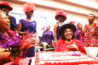 Members sing happy birthday to their eldest member Pearl Williams, bottom right, who just turned 90, during the Doolittle Red Hat Divas sixth anniversary party at Doolittle Senior Center in Las Vegas Wednesday, August 17, 2011.