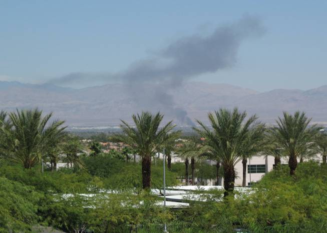 Smoke is visible across the Las Vegas Valley on Wednesday as fire damaged a shed and vehicles in the northeast valley. 
