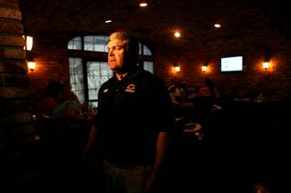 First-year Chaparral football coach, Bill Froman, is interviewed during a fundraiser hosted by the school's alumni association at Murphy's Law Pub and Grill in Las Vegas Saturday, August 20, 2011. The money raised is to update equipment and help the new coach turn the program around.
