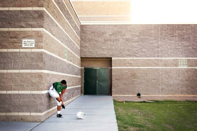 Freshman football player Joshua Aceves puts on his cleats before practice at Mojave High School in North Las Vegas on Monday, August 22, 2011.