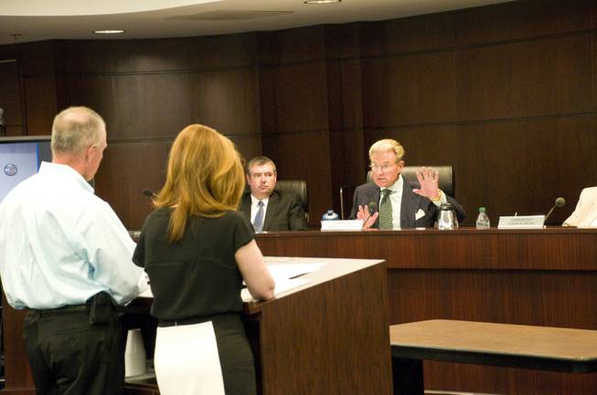 Nevada Gaming Commissioner Randolph Townsend asks Michael Eide and attorney Patty Becker, representing Dotty's Gaming & Spirits, a series of questions regarding the establishment, Thursday Aug. 25, 2011. The commission heard arguments by Dotty's regarding a change to state gaming regulations.