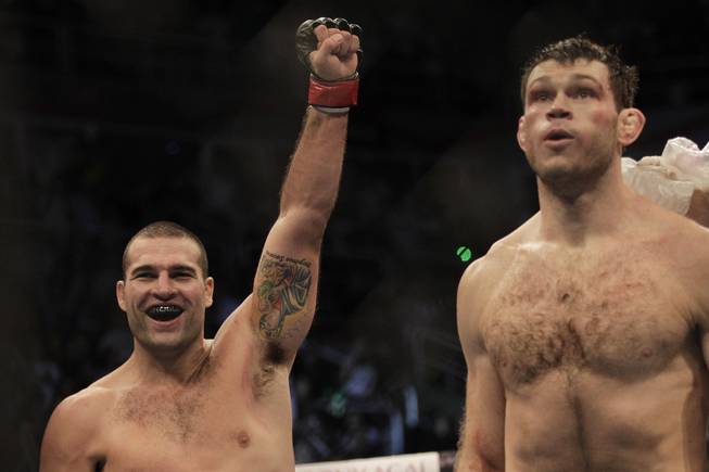 Mauricio "Shogun" Rua, left, celebrates after beating Forrest Griffin, right, via first round knockout at UFC 134 in Rio de Janeiro. Rua finished Griffin less than two minutes into their fight.