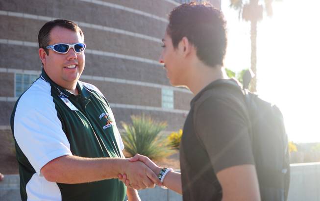 Mojave High School Assistant Principal Greg Cole shakes hands with freshman Hugo Aceves, 14, in front of the North Las Vegas high school on Monday, Aug. 29, 2011.
