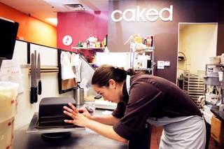 Carolyn Portuondo, owner of Caked Las Vegas, works on a birthday cake at her bakery on Wednesday, Aug. 31, 2011.