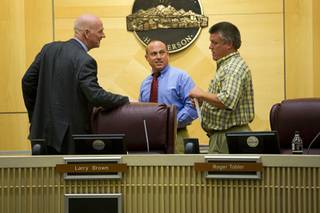 Clark County Commissioner and Regional Transportation Commission board chairman Larry Brown, left, talks with Boulder City Mayor Roger Tobler, center, and North Las Vegas Councilman Robert Eliason before going into a closed meeting at the Henderson City Council chambers Thursday, September 1, 2011. 