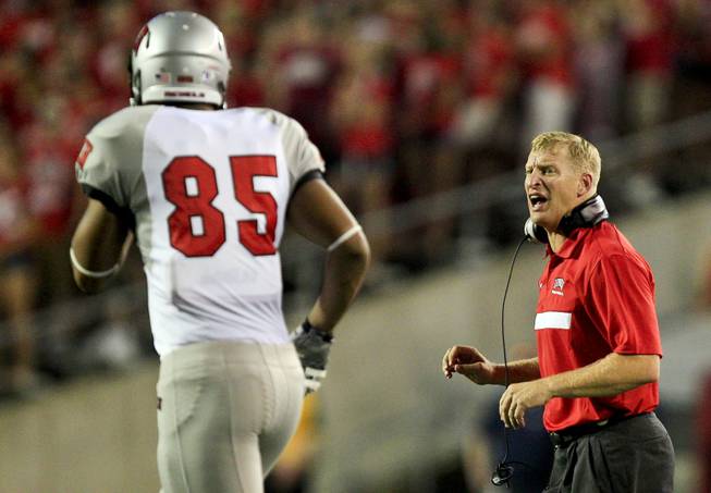 UNLV head coach Bobby Hauck, right, gives direction to Jordan Sparkman (85) during the first half of an NCAA college football game against Wisconsin, Thursday, Sept. 1, 2011, in Madison, Wis.