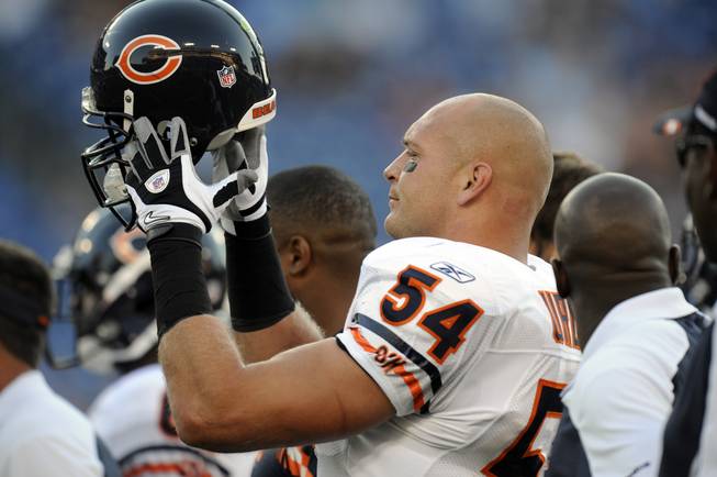 Chicago Bears linebacker Brian Urlacher puts on his helmet before an NFL preseason game between the Chicago Bears and the Tennessee Titans on Saturday, Aug. 27, 2011, in Nashville, Tenn.