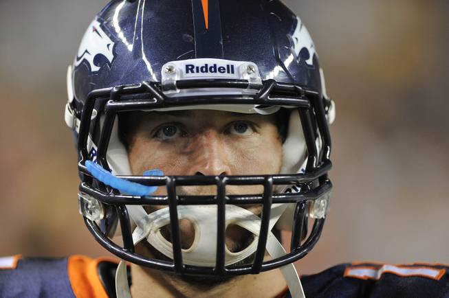  This Aug. 20, 2011 file photo shows Denver Broncos quarterback Tim Tebow watching from the sidelines before entering the game in the fourth quarter against the Buffalo Bills, during a preseason NFL football game, in Denver. 