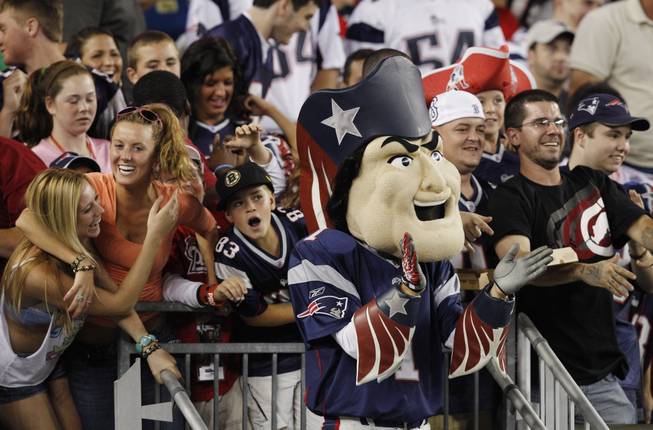 Fans react as mascot Pat Patriot applauds during an NFL preseason football game between the New England Patriots and the Jacksonville Jaguars in Foxborough, Mass., Thursday, Aug. 11, 2011.