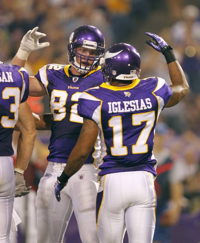 Minnesota Vikings tight end Kyle Rudolph, left, celebrates with teammate Juaquin Iglesias after scoring a touchdown during the first half of an NFL preseason football game against the Houston Texans Thursday, Sept. 1, 2011, in Minneapolis.