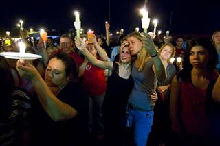 Samantha Forecki, 15, center, and her mother, Michele Enk, hold up candles during a vigil for 15-year-old Alyssa Otremba at Arbor View High School Wednesday, Sept. 7, 2011.  Otremba, an Arbor View sophomore and school band member, was found slain on Saturday, Sept. 3, 2011. 