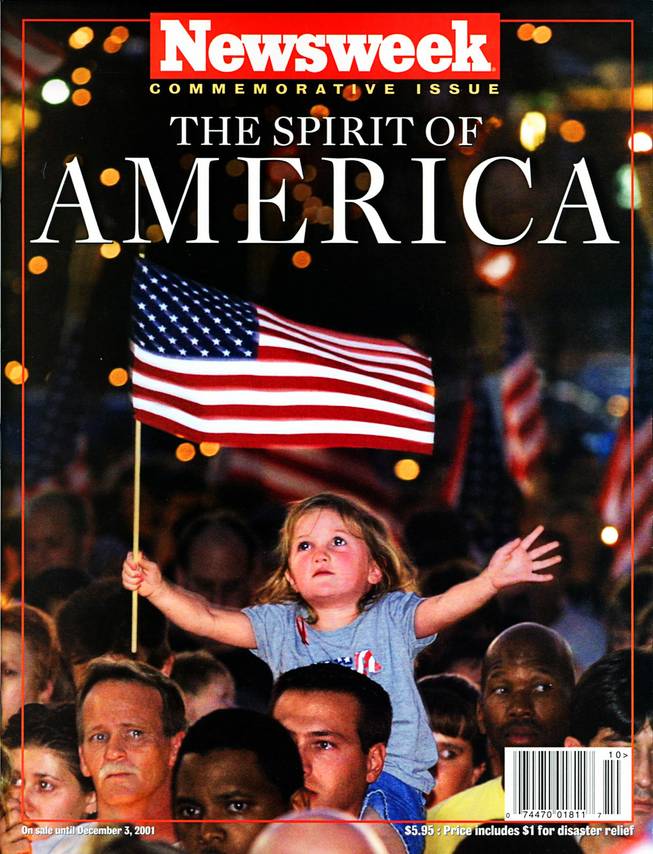 Cover of Newsweek, commemorative issue, released on Sept. 20, 2001. Original cutline reads: Alana Milawski, 3, waves an American flag as she sits on her father Craig Milawski's shoulders during a candlelight vigil at the Thomas & Mack Center Wednesday, September 12, 2001 held to honor those killed in Tuesday's terrorist attacks. ETHAN MILLER / LAS VEGAS SUN