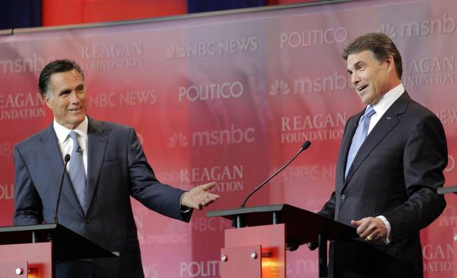 Republican presidential candidates former Massachusetts Gov. Mitt Romney, left, and Texas Gov. Rick Perry answer a question during a Republican presidential candidate debate at the Reagan Library Wednesday, Sept. 7, 2011, in Simi Valley, Calif.