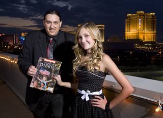 Former Las Vegas Sun photographer Ethan Miller and Alana Milawski, 13, pose with a copy of Newsweek' s Spirit of America commemorative issue after a 9/11 Remembrance opening event Friday, Sept. 9, 2011. Milawski was 3 years old when Miller photographed her on her father's shoulders during a candlelight vigil at the Thomas & Mack Center on Sept. 12, 2001.