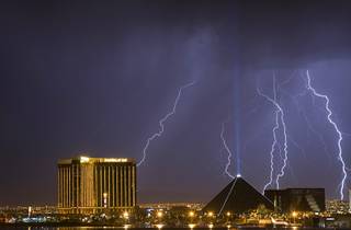 Lightning strikes behind Mandalay Bay, left, and the Luxor as a thunderstorm passes through Las Vegas early in the morning of Sept. 11, 2011.