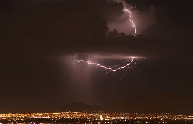 Lightning crackles above the Las Vegas Valley during a storm that passed through which brought about a half-inch of rain to North Las Vegas, knocked out power in some neighborhoods and damaged at least one home and about 20 trees, according to fire and utility officials September 13, 2011.