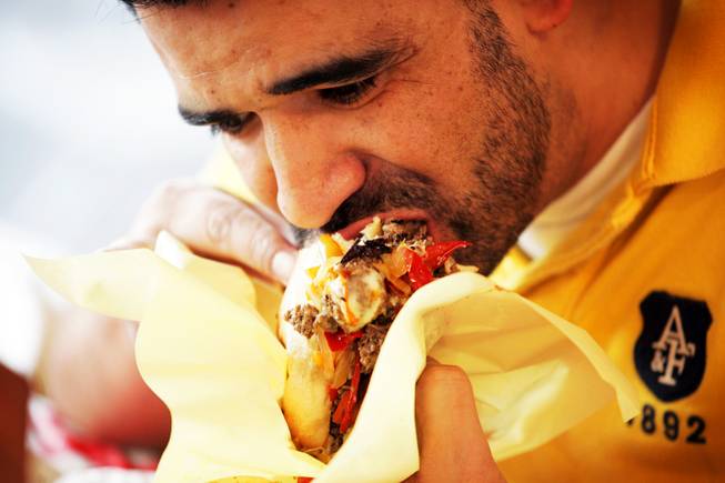 J.J. Guzman of Las Vegas takes a bite of his sandwich during the San Gennaro Feast at the Rio on Wednesday, Sept. 14, 2011.