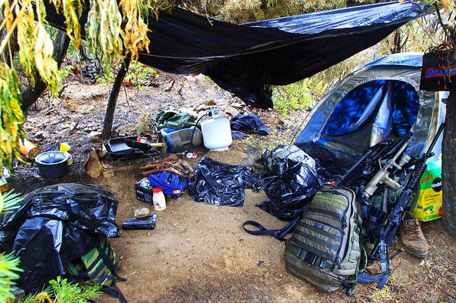 A kitchen area used by growers is seen during a raid of a marijuana operation in the Carpenter Canyon area of the Spring Mountains on Wednesday, Sept. 14, 2011. The weapons belong to law enforcement officers.