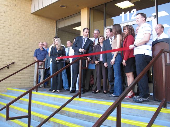 Henderson business leaders and city officials, led by Chamber of Commerce president Scott Muelrath, cut a ribbon during the 10th anniversary celebration for the Henderson Business Resource Center.