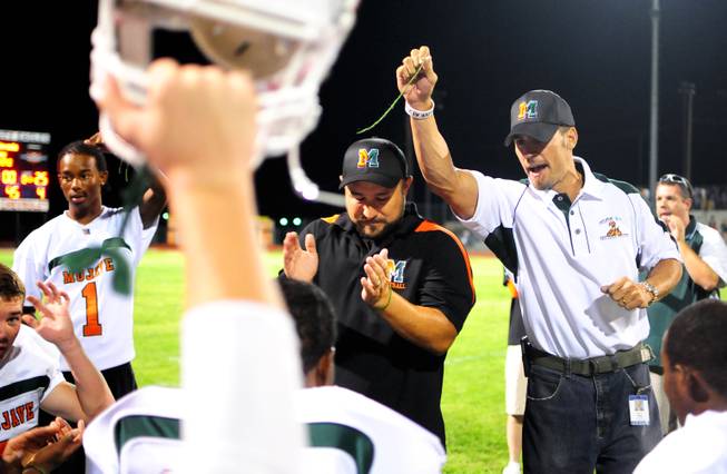 Mojave High School Principal Antonio Rael holds up a broken green wristband symbolizing breaking negative perceptions at his school with the Rattler's first win since the 2009-10 season on Friday, Sept. 24, 2011, against the Boulder City Eagles during their homecoming weekend.