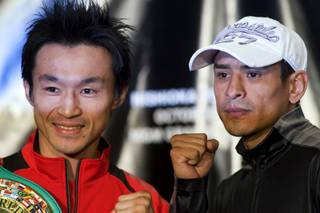 WBC super bantamweight champion Toshiaki Nishioka, left, of Japan and former champion Rafael Marquez of Mexico pose during a news conference at the MGM Grand Thursday, September 29, 2011. Nishioka will defend his title against Marquez at the MGM's Marquee Ballroom Saturday.