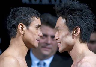 Former champion Rafael Marquez, left, of Mexico and WBC super bantamweight champion Toshiaki Nishioka of Japan face off during an official weigh-in at the MGM Grand Friday, September 30, 2011. Nishioka will defend his title against Marquez at the MGM's Marquee Ballroom Saturday.