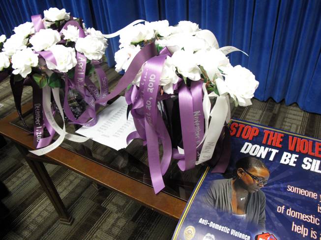 Thirty flowers, each representing a domestic violence homicide victim, fill vases at a ceremony to honor victims and kick off Domestic Violence Awareness Month. The 30 homicide victims died between July 1, 2010, and June 30, 2011.