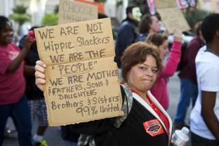 A woman who identified herself as Janelle K. holds up a sign during an Occupy Las Vegas protest on the Las Vegas Strip Thursday, Oct. 6, 2011. The protest was held in solidarity with Occupy Wall Street demonstrations in New York and in other parts of the U.S.