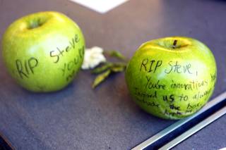 A small shrine to Steve Jobs is displayed in the window of the Apple Store in Town Square Las Vegas Friday, October 7, 2011.