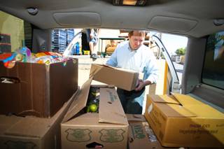 Former UNLV instructor Martin Dean Dupalo loads his vehicle with bakery and grocery items donated for nonprofit organizations at Trader Joe's on Friday, Oct. 7, 2011.