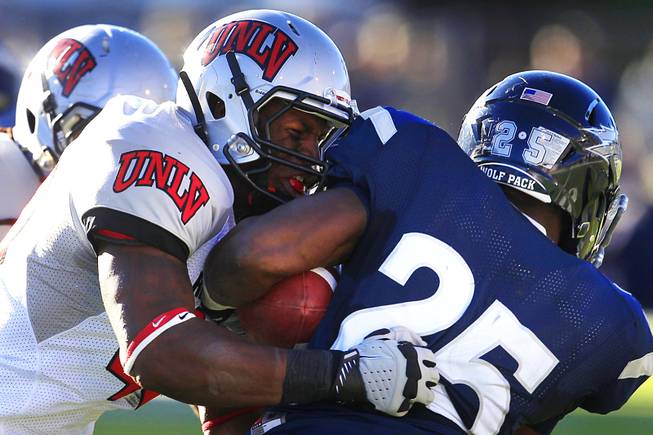 UNLV linebacker Princeton Jackson tackles UNR running back Stefphon Jefferson during their game Saturday, Oct. 8, 2011, at Mackay Stadium in Reno. UNR won the game 37-0 to extend its winning streak over UNLV to seven.
