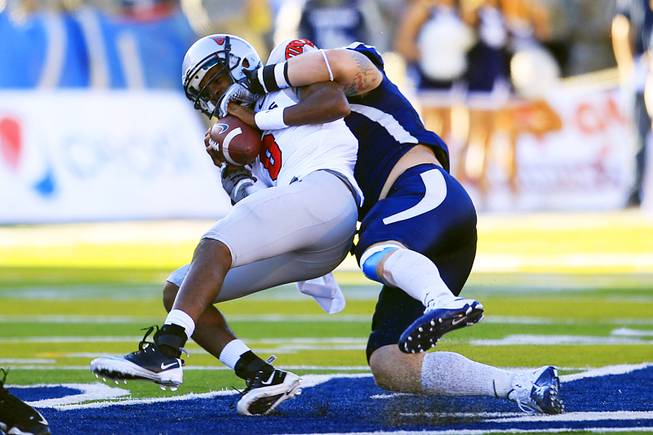 UNLV quarterback Caleb Herring gets sacked by UNR during the first half of their game Saturday, Oct. 8, 2011, at Mackay Stadium in Reno.