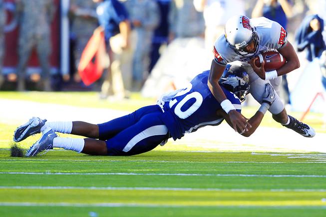 UNLV quarterback Caleb Herring is taken down for a loss by UNR defensive back Duke Williams during the first half of their game Saturday, Oct. 8, 2011, at Mackay Stadium in Reno.