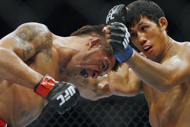 Nam Phan, right, fights Leonard Garcia in a featherweight bout where Phan won in three rounds before the UFC 136 lightweight title bout with Gray "The Bully" Maynard and Frankie "The Answer" Edgar at Toyota Center Saturday, Oct. 8, 2011, in Houston.