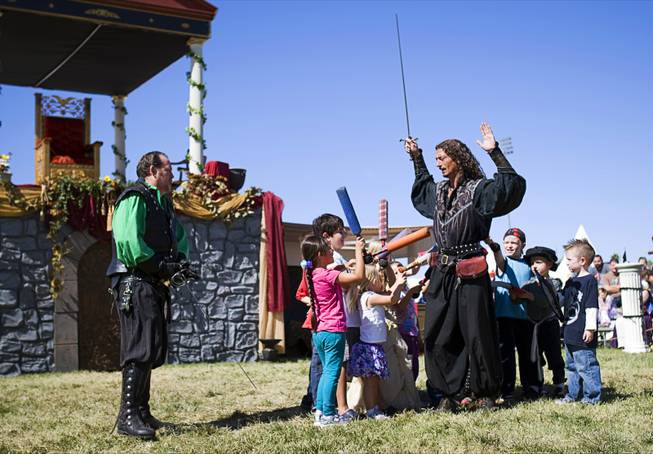 "Capt. Griffin" (Tawn Jones) enlists children from the audience to subdue his partner "Guido" (Jeff Winters) during a "Nature of Mercy" performance at the Age of Chivalry Renaissance Festival in Silver Bowl Park on Sunday, Oct. 9, 2011.