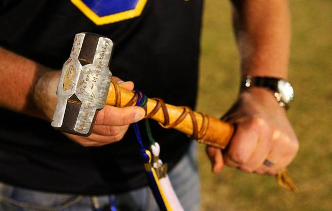 Moapa Valley High School Principal Grant Hanevold holds the "Victory Hammer," a rivalry trophy, during a game between Virgin Valley High School and Moapa Valley High School in Overton on Friday, Oct. 14, 2011. The Moapa Pirates shut out the Bulldogs 18-0 to retain the hammer.