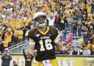 Wyoming quarterback Brett Smith celebrates his touchdown catch on a trick play during an NCAA college football game against UNLV on Saturday, Oct. 15, 2011, at War Memorial Stadium in Laramie, Wyo.