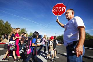 Fred Peters, the grandfather of a student, directs traffic at Paiute Peak Avenue and Gagnier Boulevard after classes at Wright Elementary School in southwest Las Vegas on Tuesday, Oct. 18, 2011.