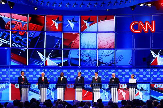 Rick Santorum, Ron Paul, Herman Cain, Mitt Romney, Rick Perry, Newt Gingrich and Michele Bachmann are seen during the GOP presidential debate sponsored by CNN on Tuesday, Oct. 18, 2011, at the Venetian.