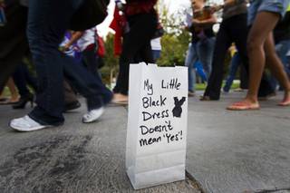 Marchers pass by a luminary with a message during the annual 