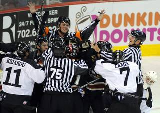 ECHL referee Nick Leduc attempts to restore order as a scuffle breaks out in front of the Las Vegas net during first-period action between the Wranglers and the Condors on Saturday night at the Orleans Arena.