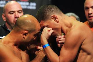 B.J. Penn, left, and Nick Diaz bump heads while facing off during the weigh in Friday, Oct. 28, 2011 for UFC 137 at the Mandalay Bay Events Center.